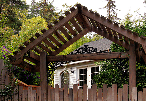 A garden gate and detached entertainment cottage in the town of Martinez, CA.